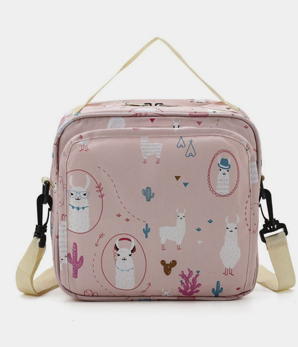 pink baby diaper bag with a llama and cactus print